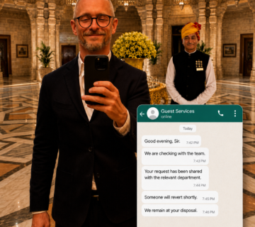 Philippe Servais holding a phone in a luxury hotel lobby beside a hotel butler, with anonymous Guest Services WhatsApp messages illustrating modern hotel service 